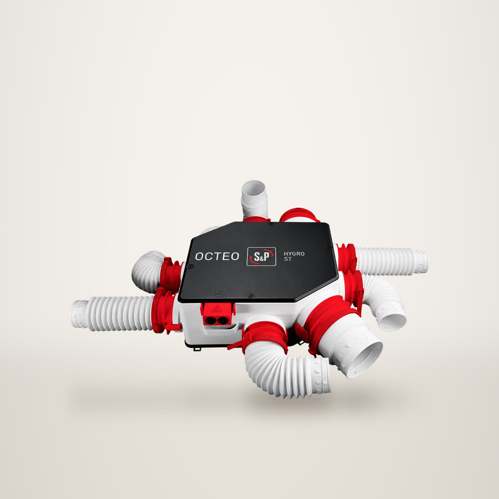 Caisson de ventilation VMC Octeo avec ses gaines flexibles blanches et rouges, sur fond de studio